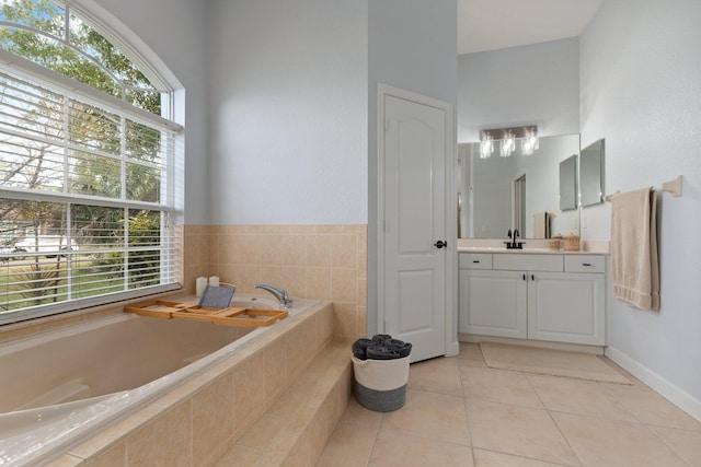 bathroom with tile patterned floors, vanity, and tiled bath