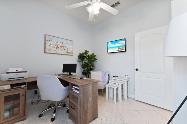 tiled home office featuring ceiling fan