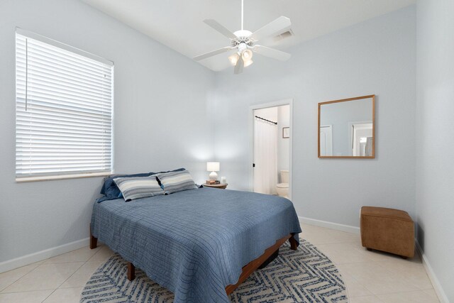 tiled bedroom with connected bathroom and ceiling fan