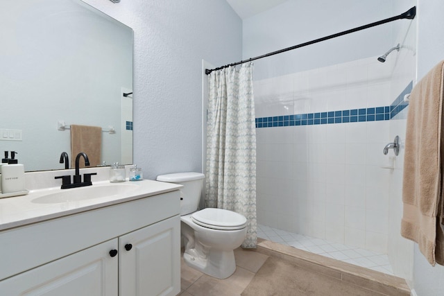 bathroom with a shower with curtain, tile patterned floors, vanity, and toilet