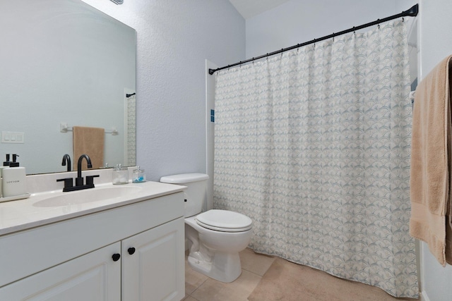 bathroom featuring vanity, tile patterned floors, and toilet