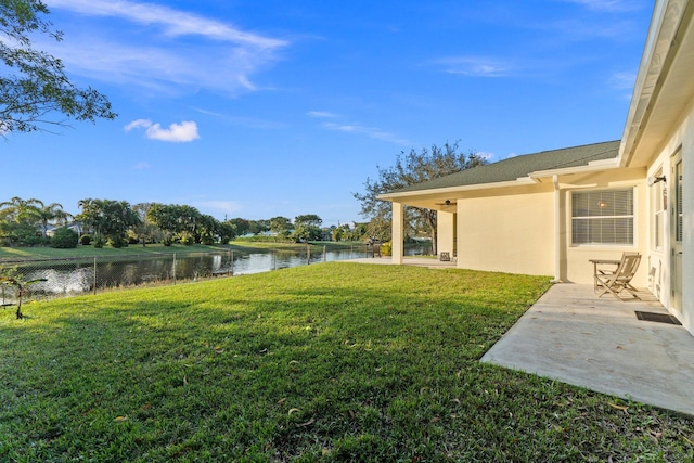 view of yard with a patio and a water view