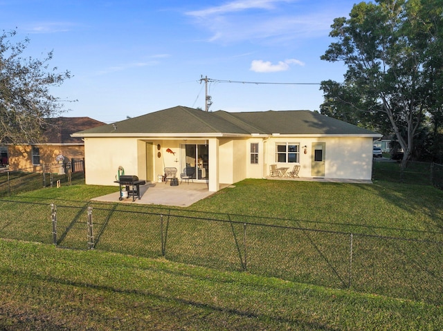 back of house with a yard and a patio