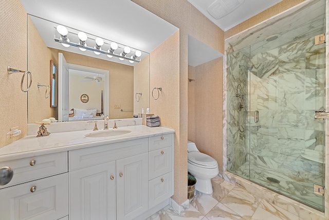 bathroom featuring an enclosed shower, vanity, toilet, and ceiling fan