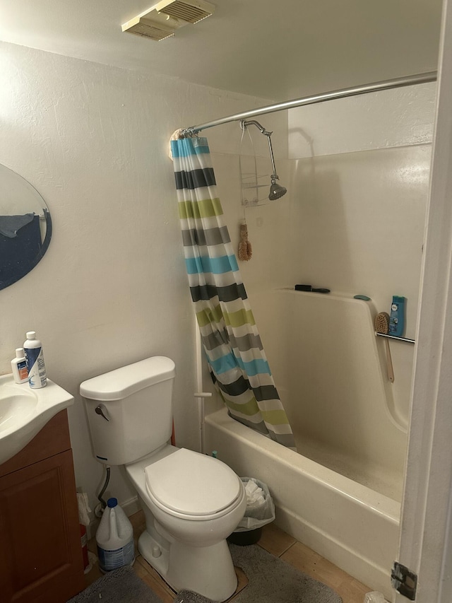 full bathroom featuring shower / bathtub combination with curtain, vanity, tile patterned flooring, and toilet