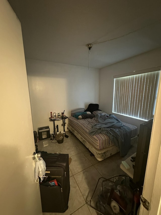 bedroom with light tile patterned floors