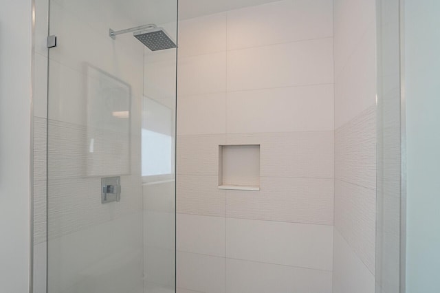 bathroom with a tile shower