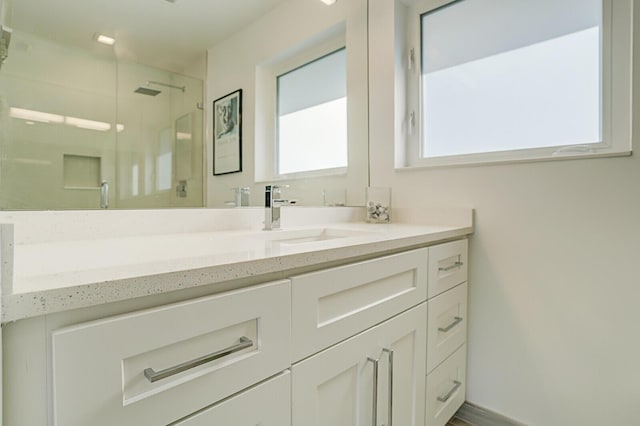 bathroom featuring vanity and an enclosed shower