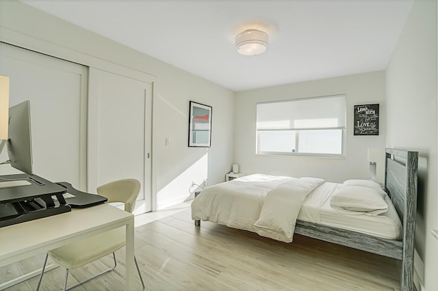 bedroom featuring a closet and light hardwood / wood-style flooring