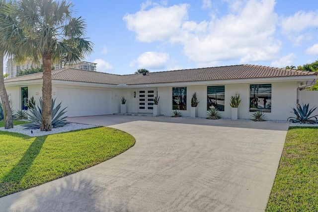 view of front of house featuring a garage and a front yard