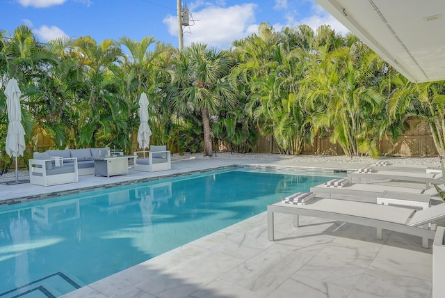 view of pool featuring an outdoor living space and a patio