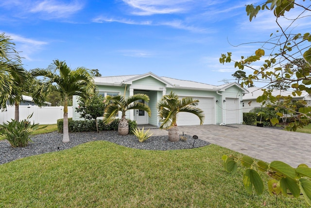 single story home with a garage and a front lawn