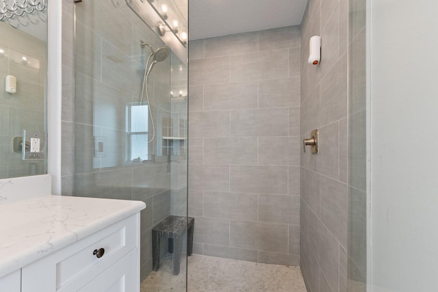 bathroom featuring vanity and tiled shower