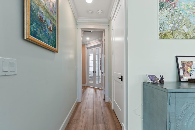 hall featuring ornamental molding and light hardwood / wood-style flooring