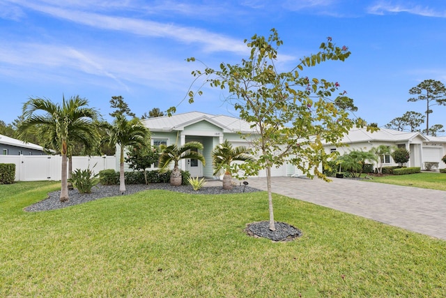 ranch-style home with a garage and a front yard