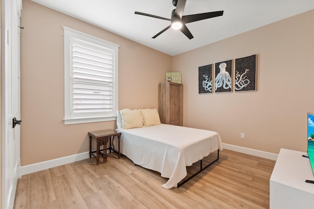 bedroom with ceiling fan and light wood-type flooring