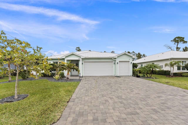 view of front of property with a garage and a front yard