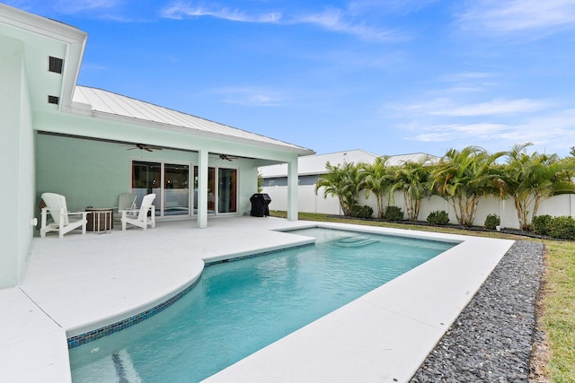 view of pool with a patio and ceiling fan