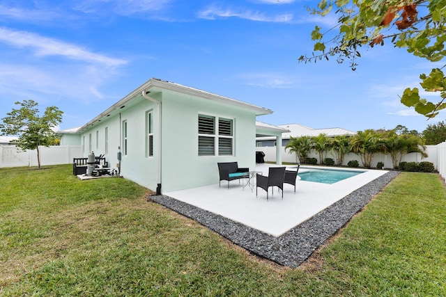 back of house with a fenced in pool, a patio, and a lawn