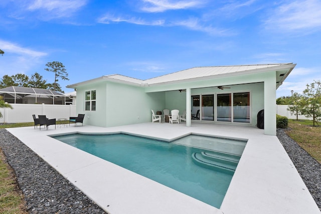 view of swimming pool with ceiling fan and a patio