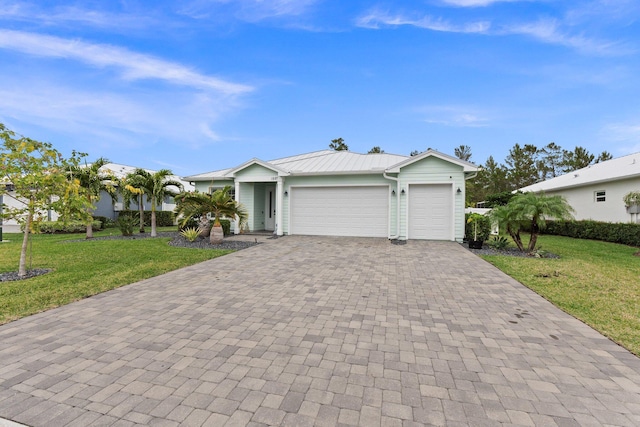 single story home featuring a garage and a front lawn