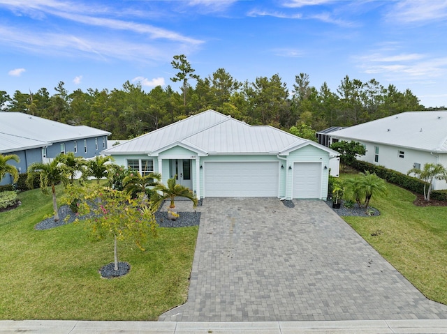 ranch-style home featuring a garage and a front lawn