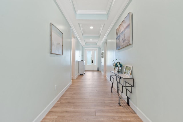 hallway with ornamental molding and light hardwood / wood-style floors