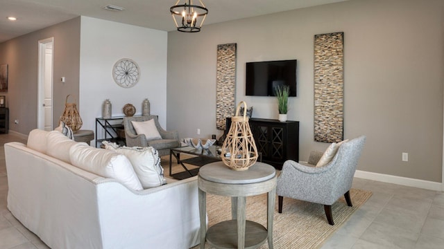 tiled living room with a notable chandelier