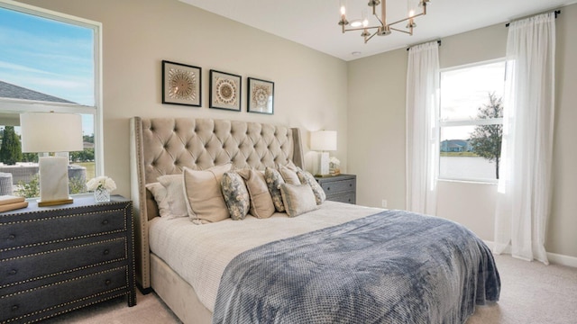 carpeted bedroom with multiple windows and an inviting chandelier