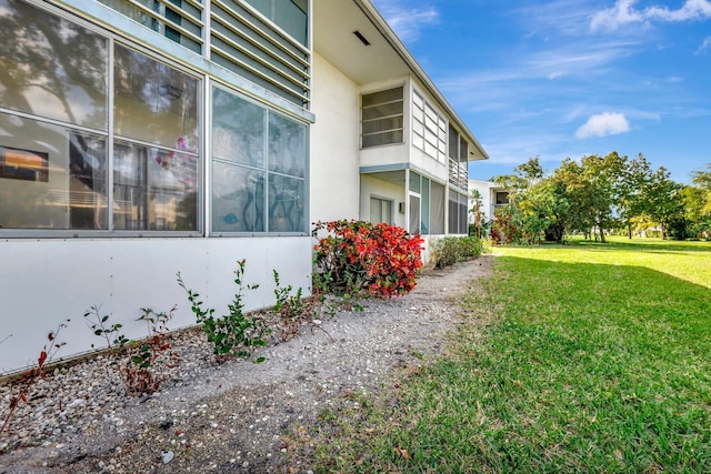 view of property exterior featuring a lawn