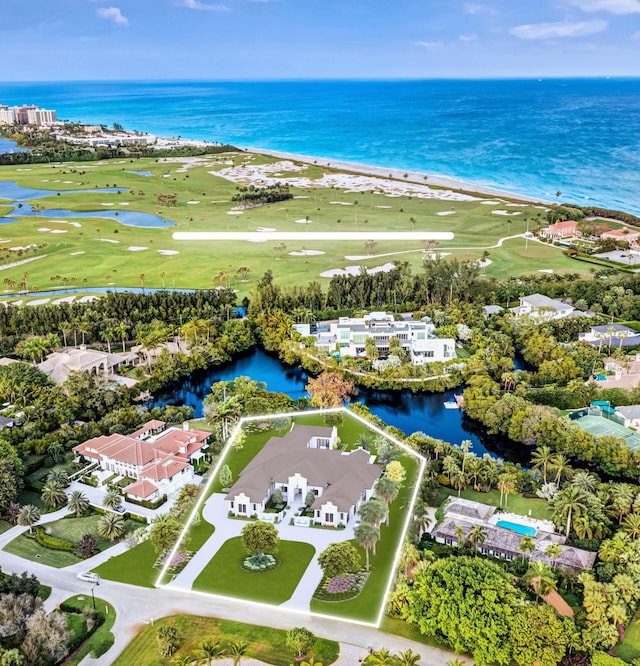 bird's eye view with a water view and a beach view