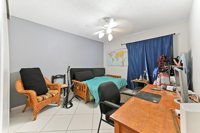 bedroom with light tile patterned flooring, ceiling fan, and a textured ceiling