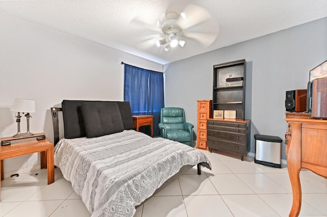 tiled bedroom with ceiling fan and a textured ceiling