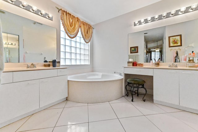 bathroom featuring visible vents, a sink, two vanities, tile patterned floors, and a garden tub