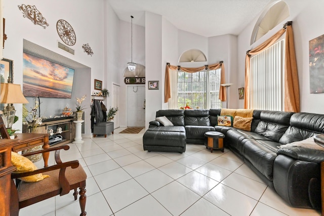 living room featuring light tile patterned floors and a high ceiling