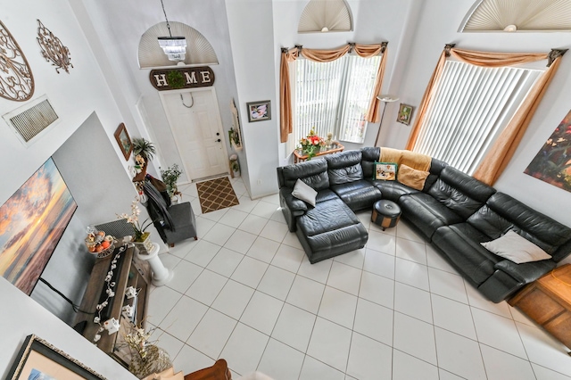 tiled living room with a towering ceiling