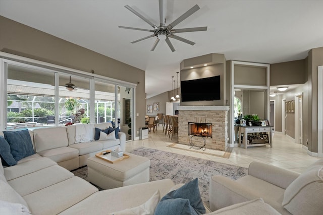 tiled living room featuring lofted ceiling, a fireplace, and ceiling fan