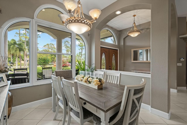 dining area with light tile patterned floors and an inviting chandelier