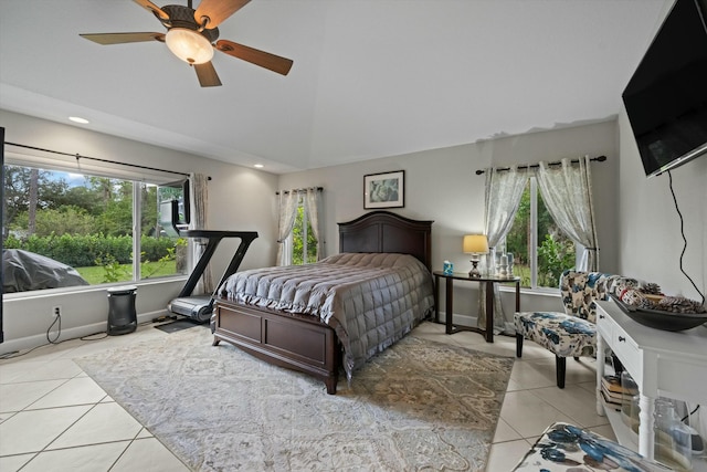 bedroom featuring ceiling fan, lofted ceiling, multiple windows, and light tile patterned floors