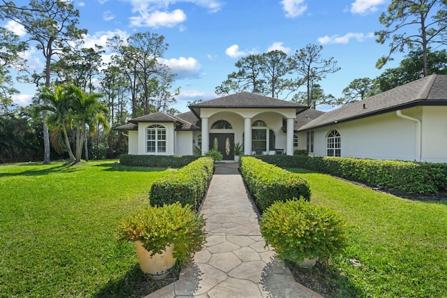 mediterranean / spanish-style house with a front yard