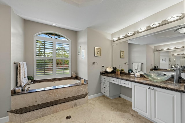 bathroom featuring vanity and tiled bath