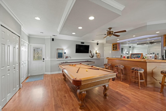 playroom with crown molding, indoor bar, ceiling fan, and hardwood / wood-style floors