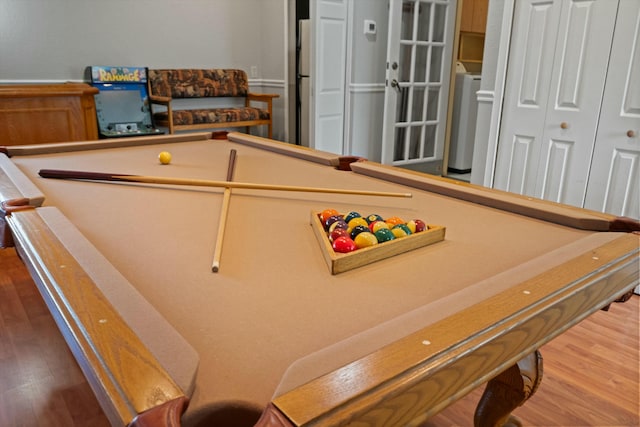 recreation room with washer / clothes dryer, wood-type flooring, and billiards