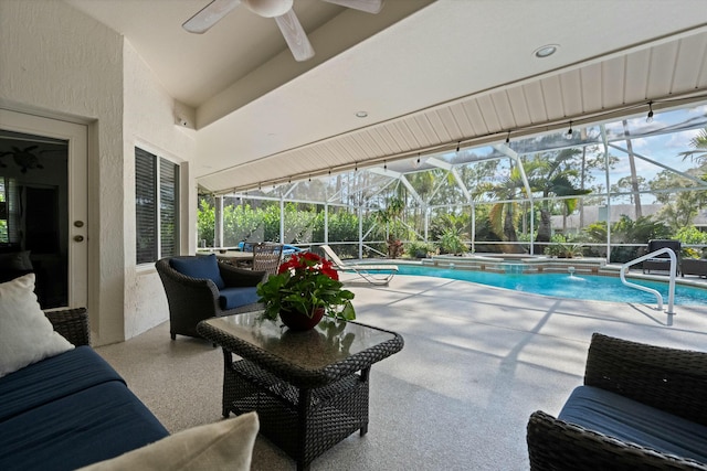 view of swimming pool with an outdoor living space, a lanai, and a patio area