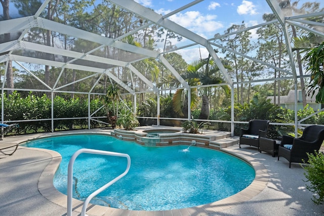 view of pool featuring pool water feature, a patio, glass enclosure, and an in ground hot tub