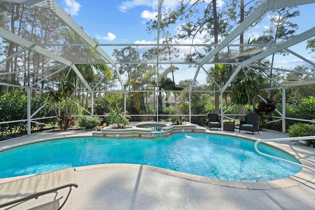 view of swimming pool with a patio area, pool water feature, glass enclosure, and an in ground hot tub