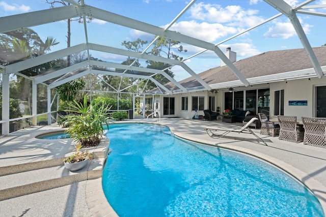 view of swimming pool with an outdoor living space, a lanai, a patio area, and pool water feature