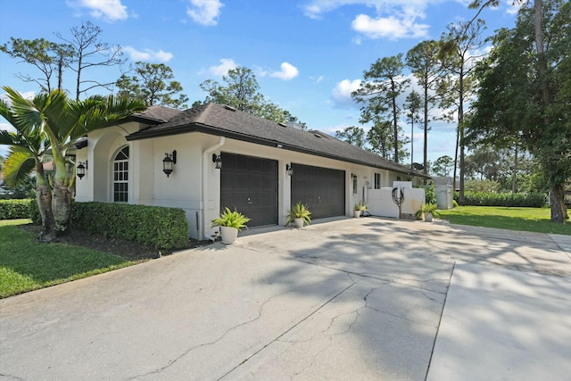 view of side of property with a garage and a yard