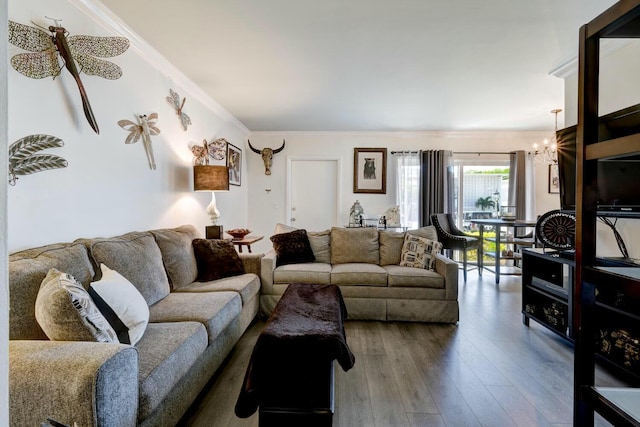 living room with hardwood / wood-style flooring, ornamental molding, and a chandelier