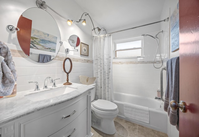 full bathroom with shower / tub combo with curtain, tile walls, vanity, toilet, and tile patterned floors